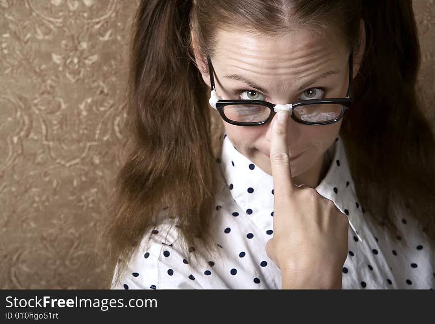 Nerdy Girl Pushing Up on her Taped Corrective Glasses