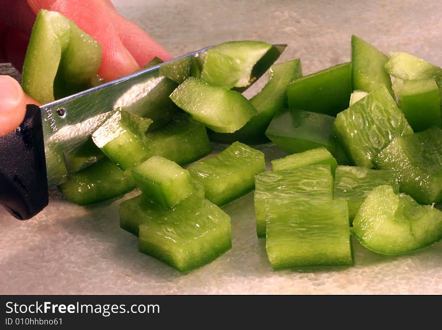 Macro of green peppers being chopped for dinner. Macro of green peppers being chopped for dinner