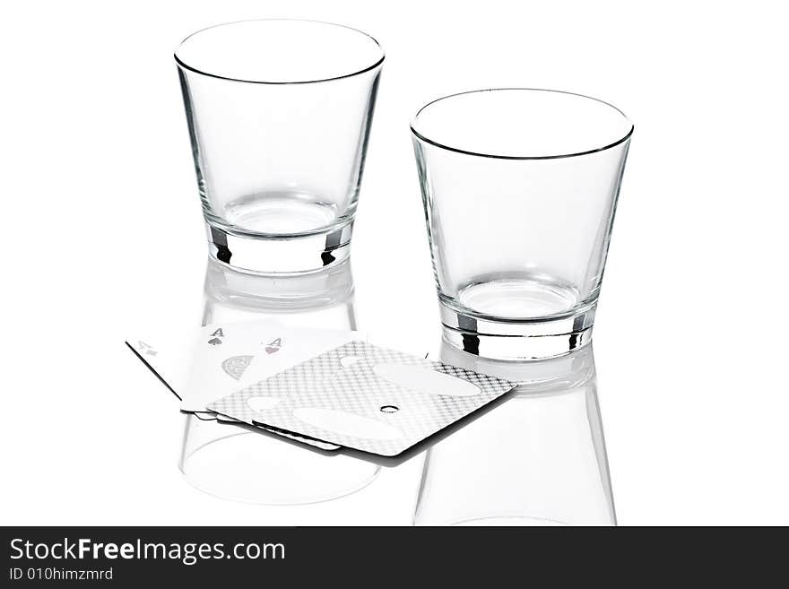 Two empty whiskey glasses with cards isolated on white