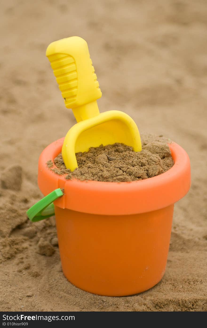 Plastic children toys lying in the sand. Plastic children toys lying in the sand