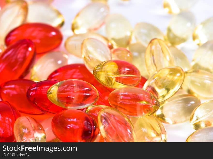 Yellow and red vitamin pills background. Yellow and red vitamin pills background