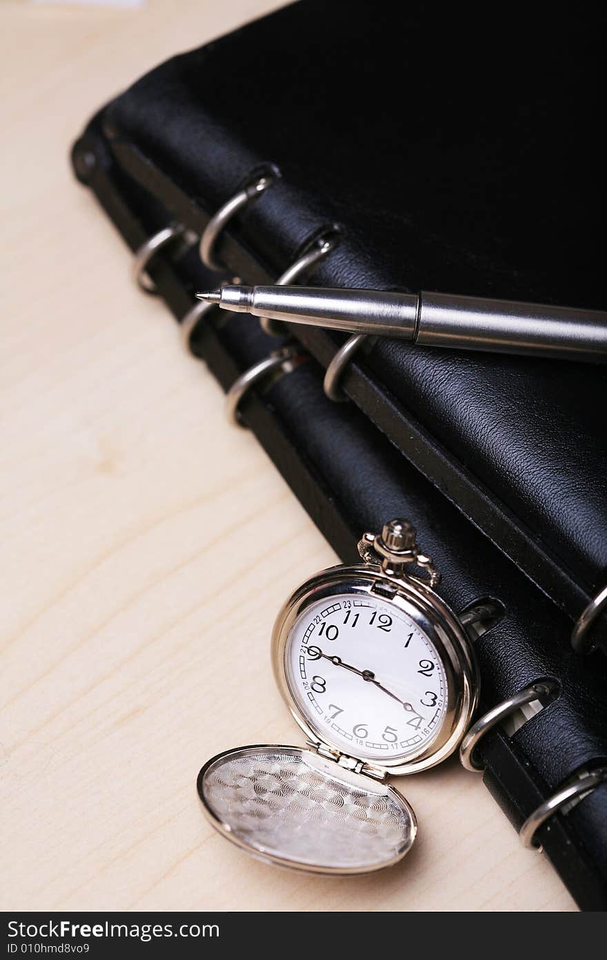 Pocket watch with black notebook. Pocket watch with black notebook