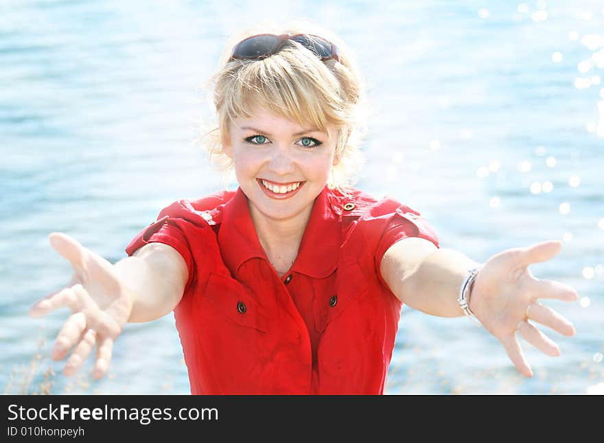 Beautiful blonde in a red dress on a sea resort. Beautiful blonde in a red dress on a sea resort