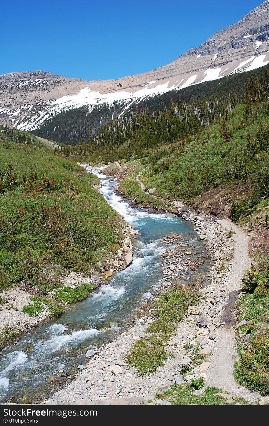 River valley and snow mountains in glacier national park, USA