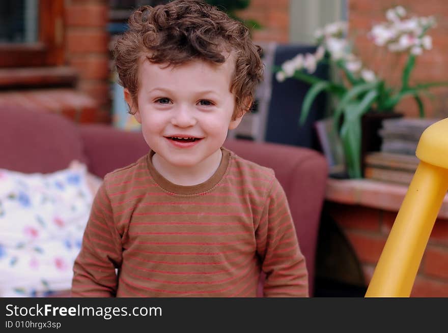 A young child laughs into the camera. A young child laughs into the camera.