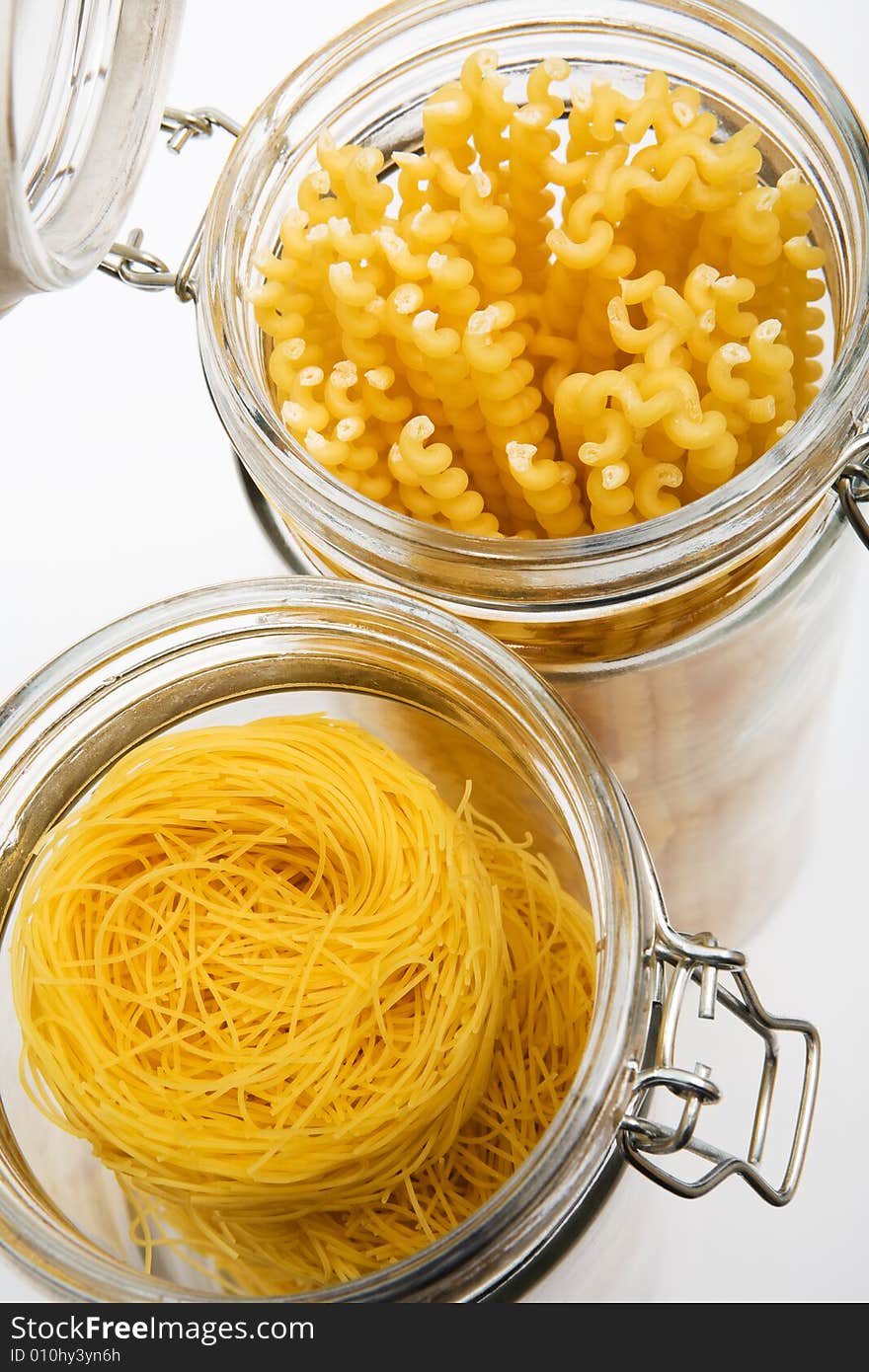 Pasta in glass can on a white background