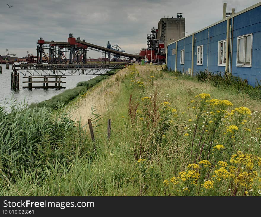 A factory with a old supermarket in front in one of the ports of Rotterdam, HDR image. A factory with a old supermarket in front in one of the ports of Rotterdam, HDR image