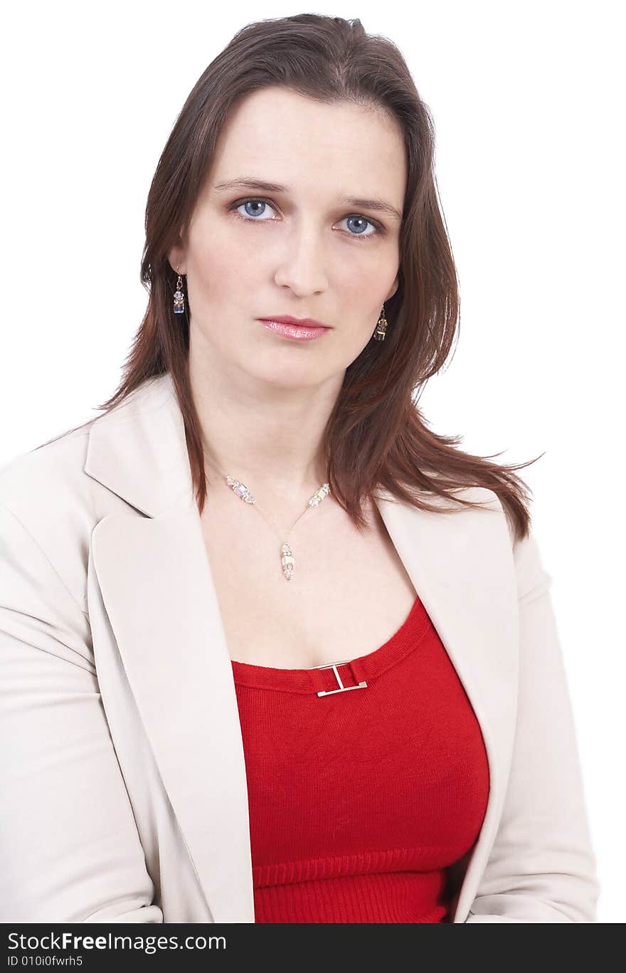 Beautiful brunette businesswoman wearing a beige jacket and a red top. Isolated on white background