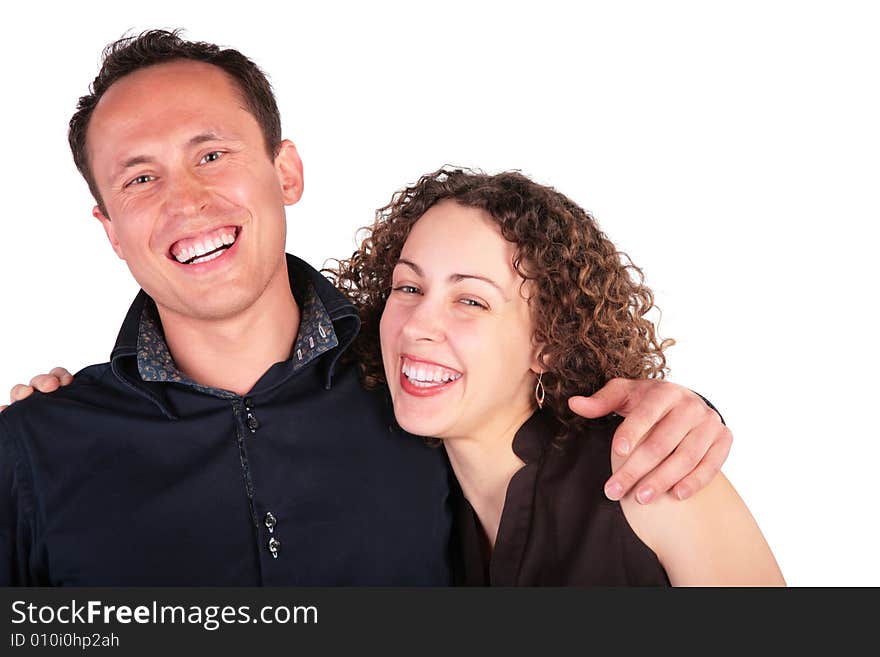 Young pair embraces and laughs loudly on white