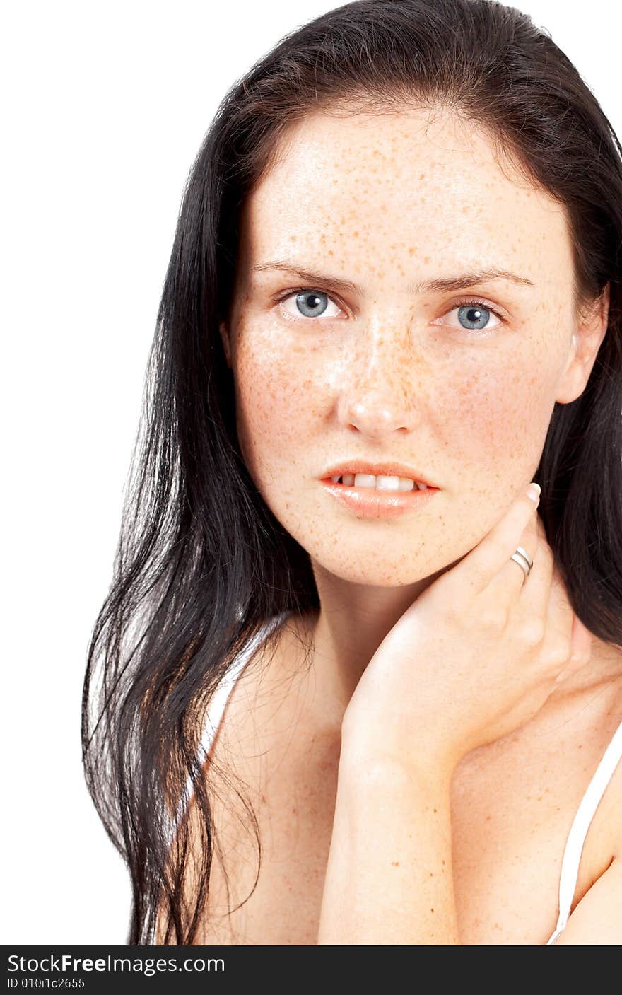 Portrait of a beautiful brunette woman with light grey eyes and freckles on her skin. Portrait of a beautiful brunette woman with light grey eyes and freckles on her skin