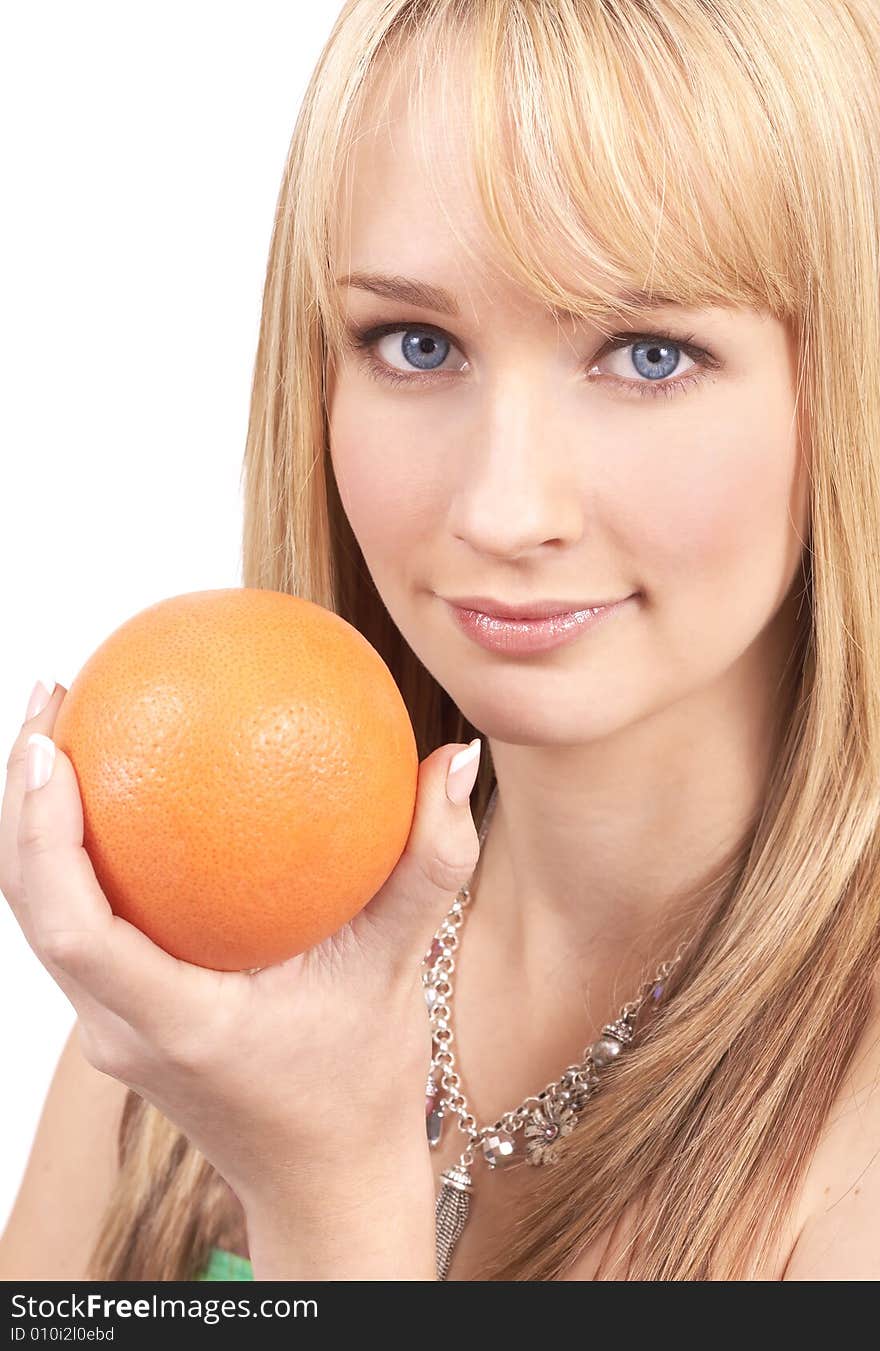 Portrait of a beautiful blonde woman with light blue eyes, holding a yellow grapefruit. Portrait of a beautiful blonde woman with light blue eyes, holding a yellow grapefruit