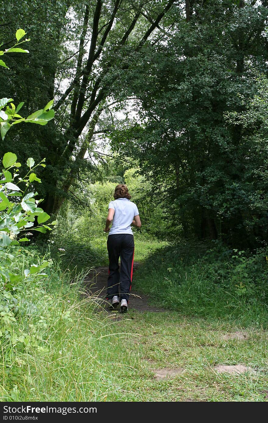 Female jogger in forest