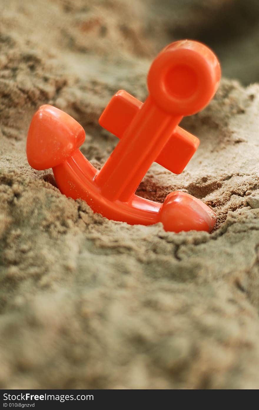 Toy anchor in sand