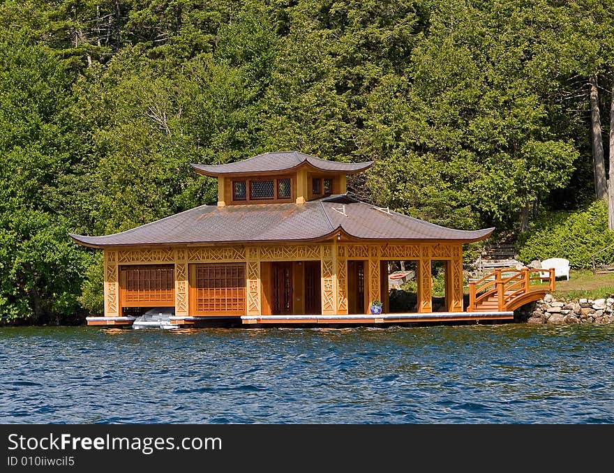 Oriental building on the water like a pagoda with boats inside. Oriental building on the water like a pagoda with boats inside