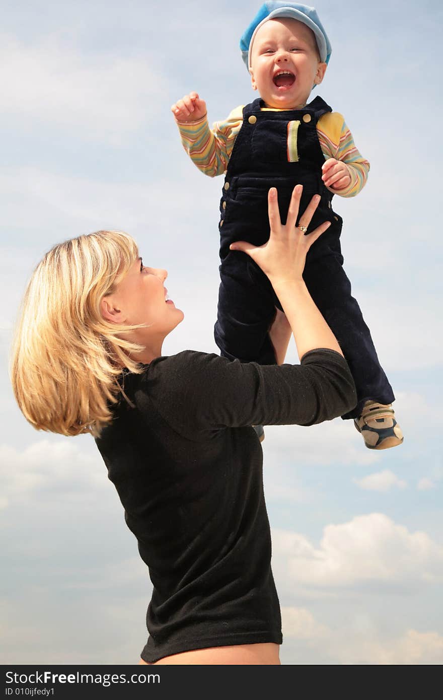 Mother lifts the child on hands