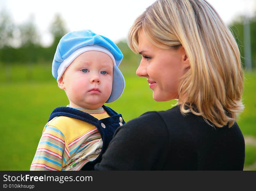 The portrait mother with son on hands