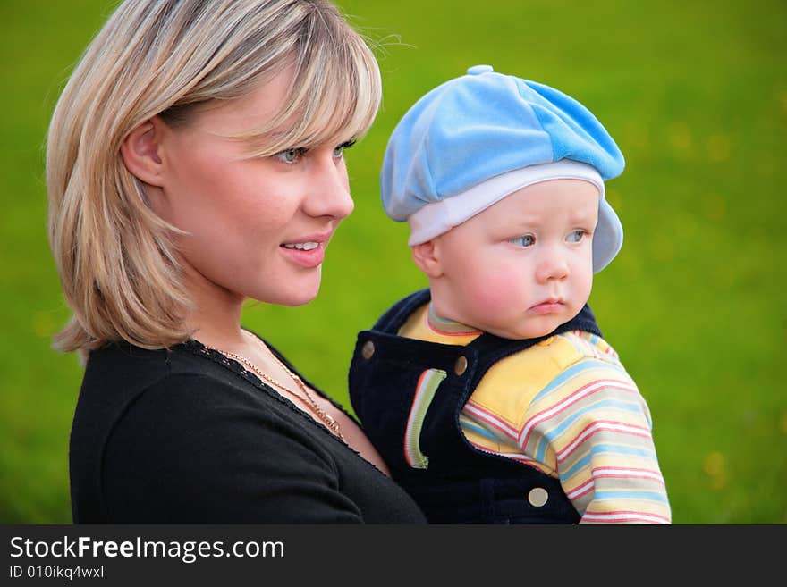 Close-up portrait of mother with son on hands