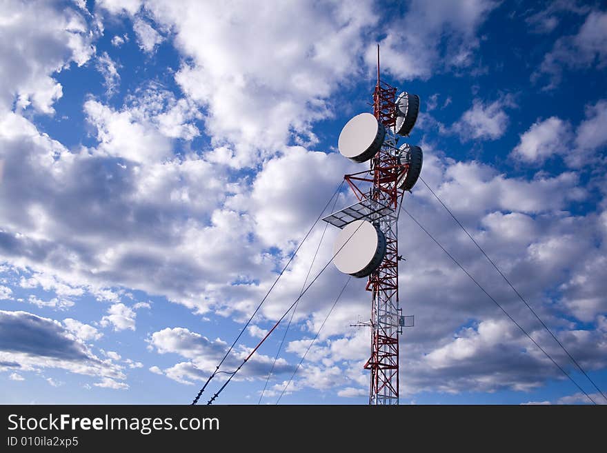 A lattice communication tower with clouds in behind. A lattice communication tower with clouds in behind