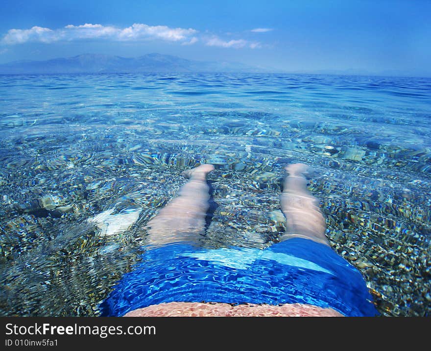 Man relaxing in water at the beach. Man relaxing in water at the beach