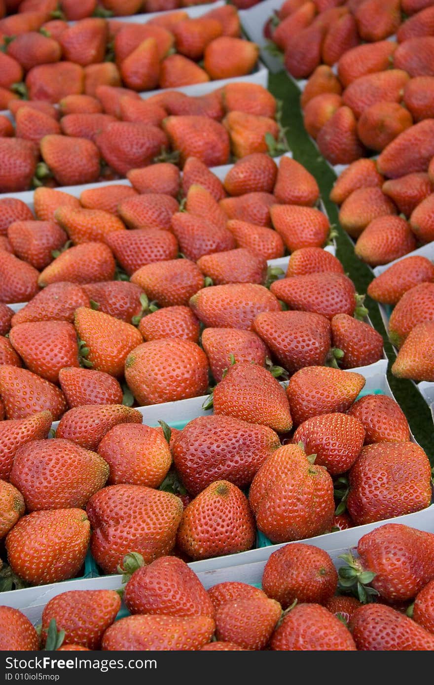 Fresh strawberries in baskets at local farmers' market