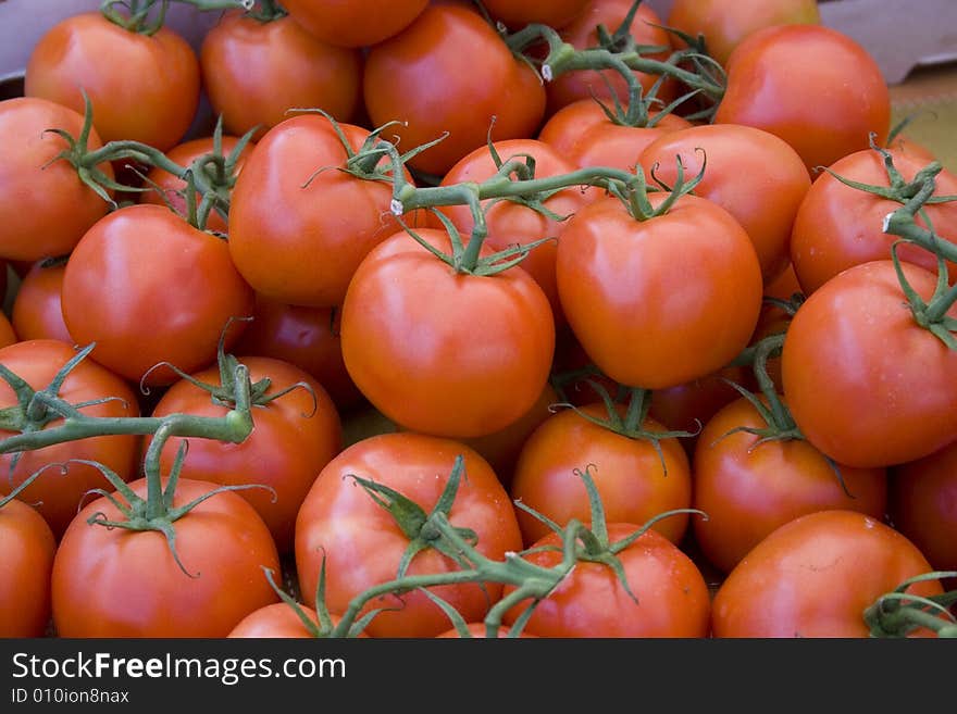 Red tomatoes with stems at the local farmers' market