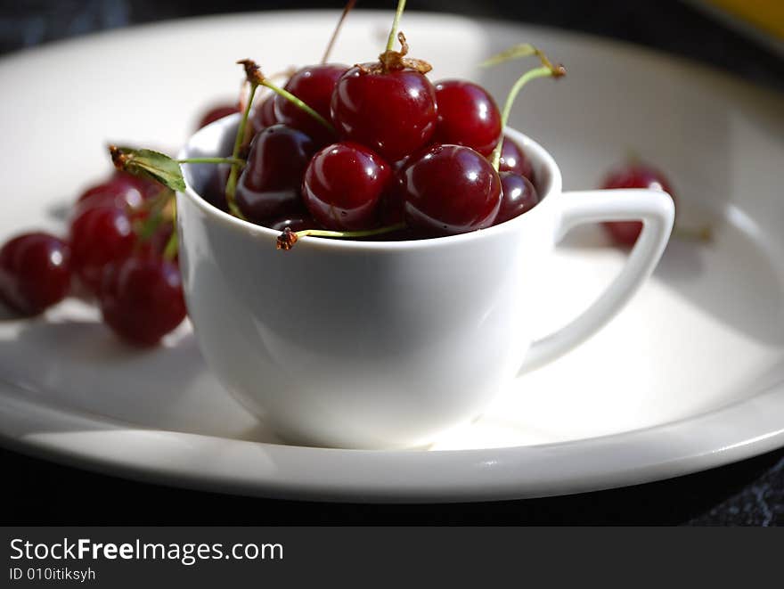 Sour cherries in a coffee cup