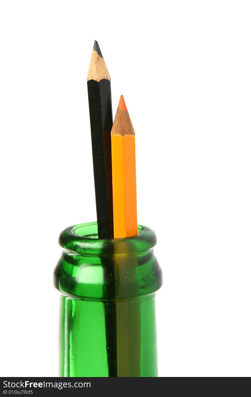 Two pencils in green bottle. Two pencils in green bottle