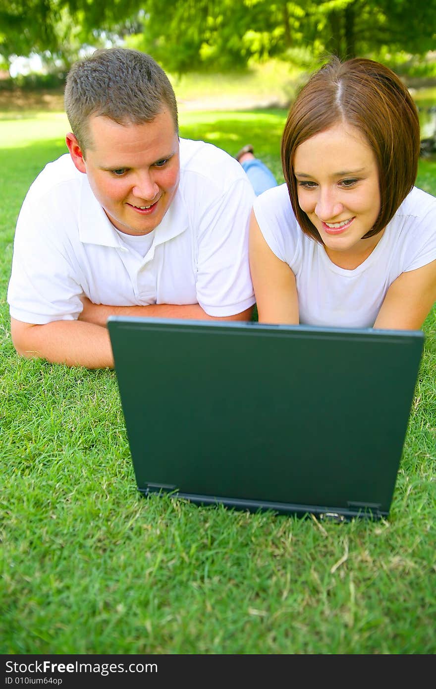 Couple Looking At Laptop With Smile