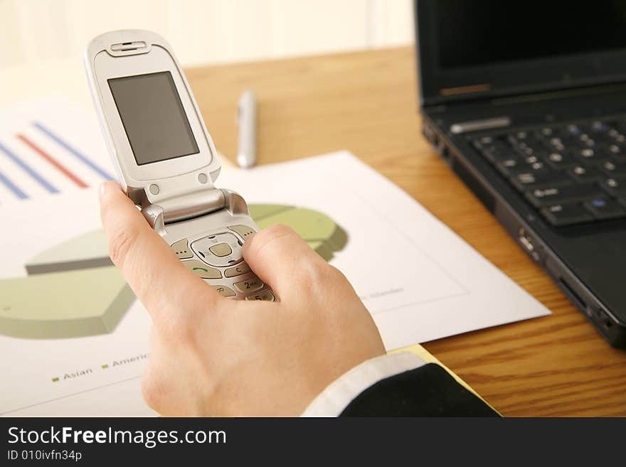 Shot of hand of business woman holding cellphone and getting ready to make a call. Shot of hand of business woman holding cellphone and getting ready to make a call