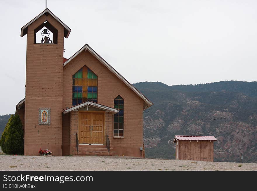 Church in the desert overshadows little shack. Church in the desert overshadows little shack