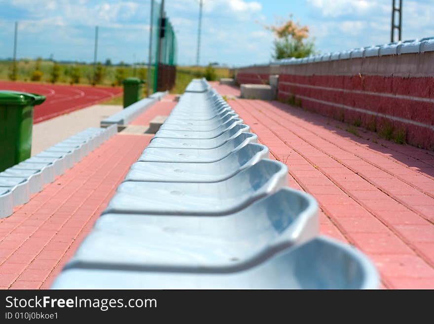 The lines of plastic chairs on sport stadium