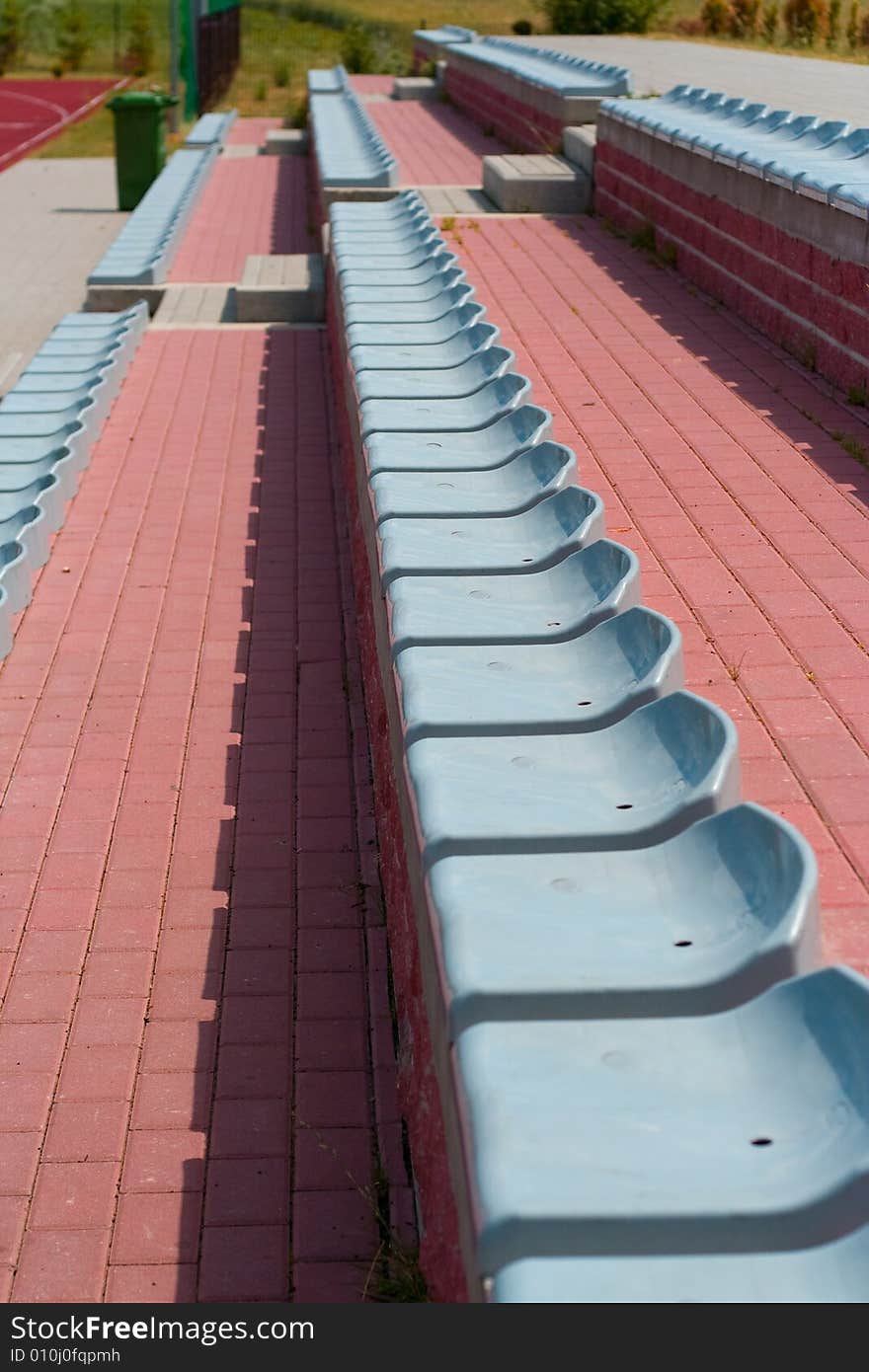 The lines of plastic chairs on sport stadium