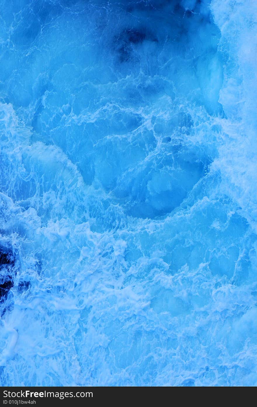 Close up of the foam of a breaking wave, suitable as a graphic background.