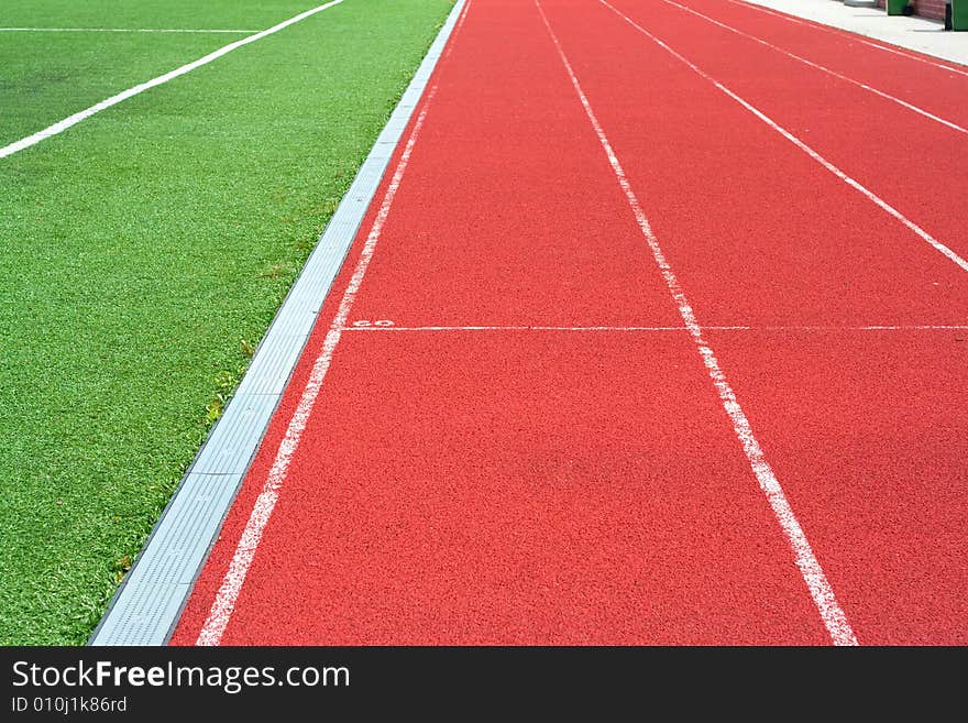 Red tartan athletic track on the stadium