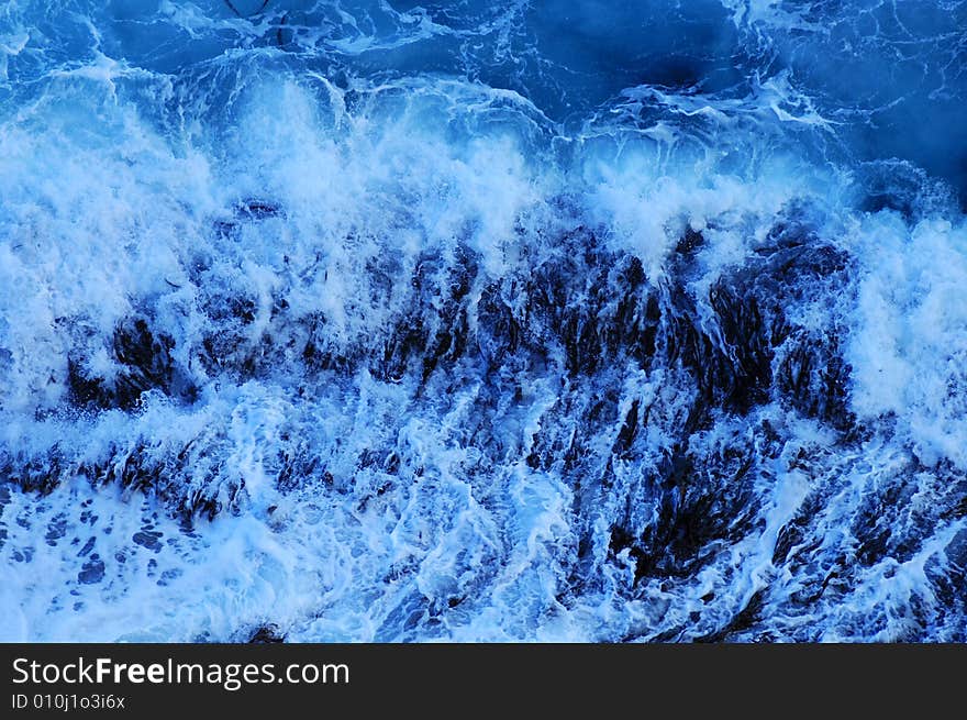 Close up of the foam of a breaking wave, suitable as a graphic background.