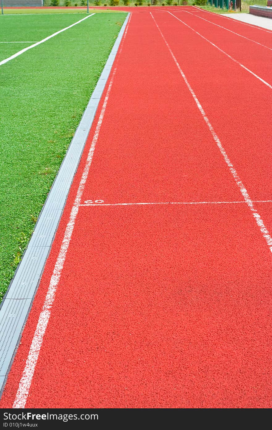 Red tartan athletic track on the stadium