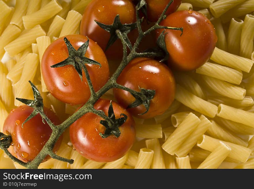 Red tomatoes with water drops and pasta. Red tomatoes with water drops and pasta