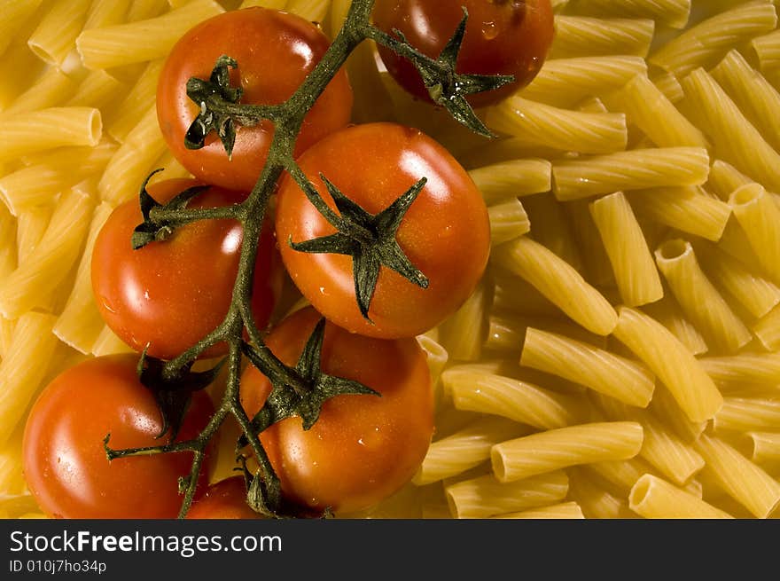 Red tomatoes with water drops and pasta. Red tomatoes with water drops and pasta