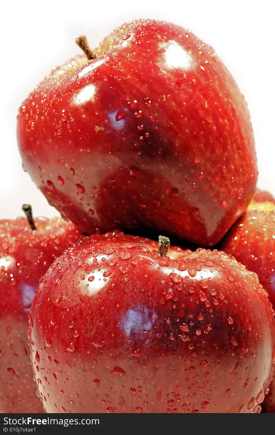 Pile of red apples with drops of water isolated on a white background. Pile of red apples with drops of water isolated on a white background.