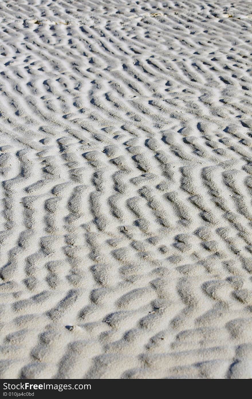 Sand ripple naturally formed by the low tide on the beach. Sand ripple naturally formed by the low tide on the beach.