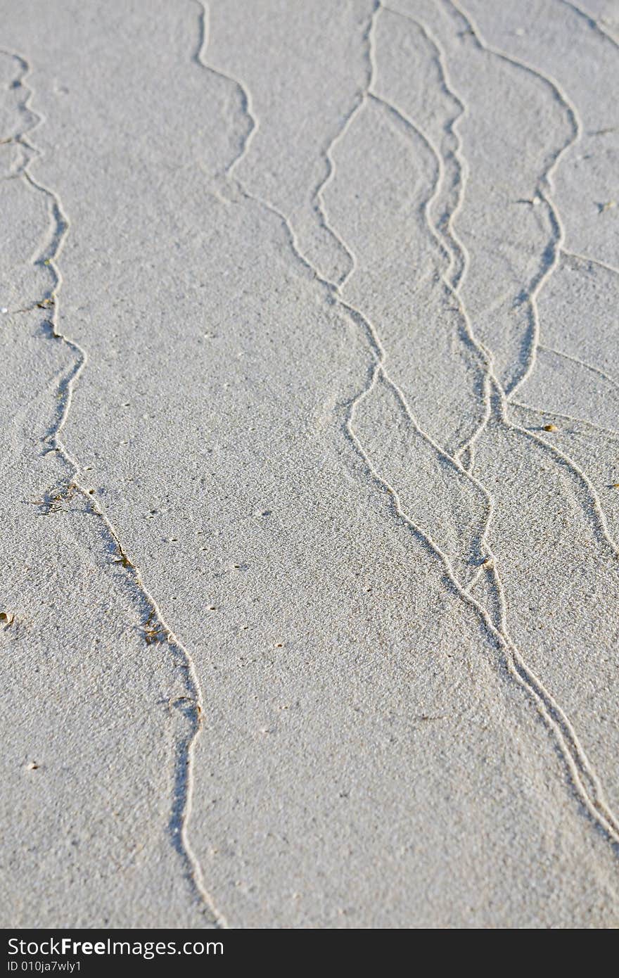 Sand ripples formed by the bathing water tide on the beach. Sand ripples formed by the bathing water tide on the beach.