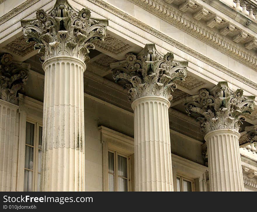 Three stone concrete columns with ornate pedestals. Three stone concrete columns with ornate pedestals