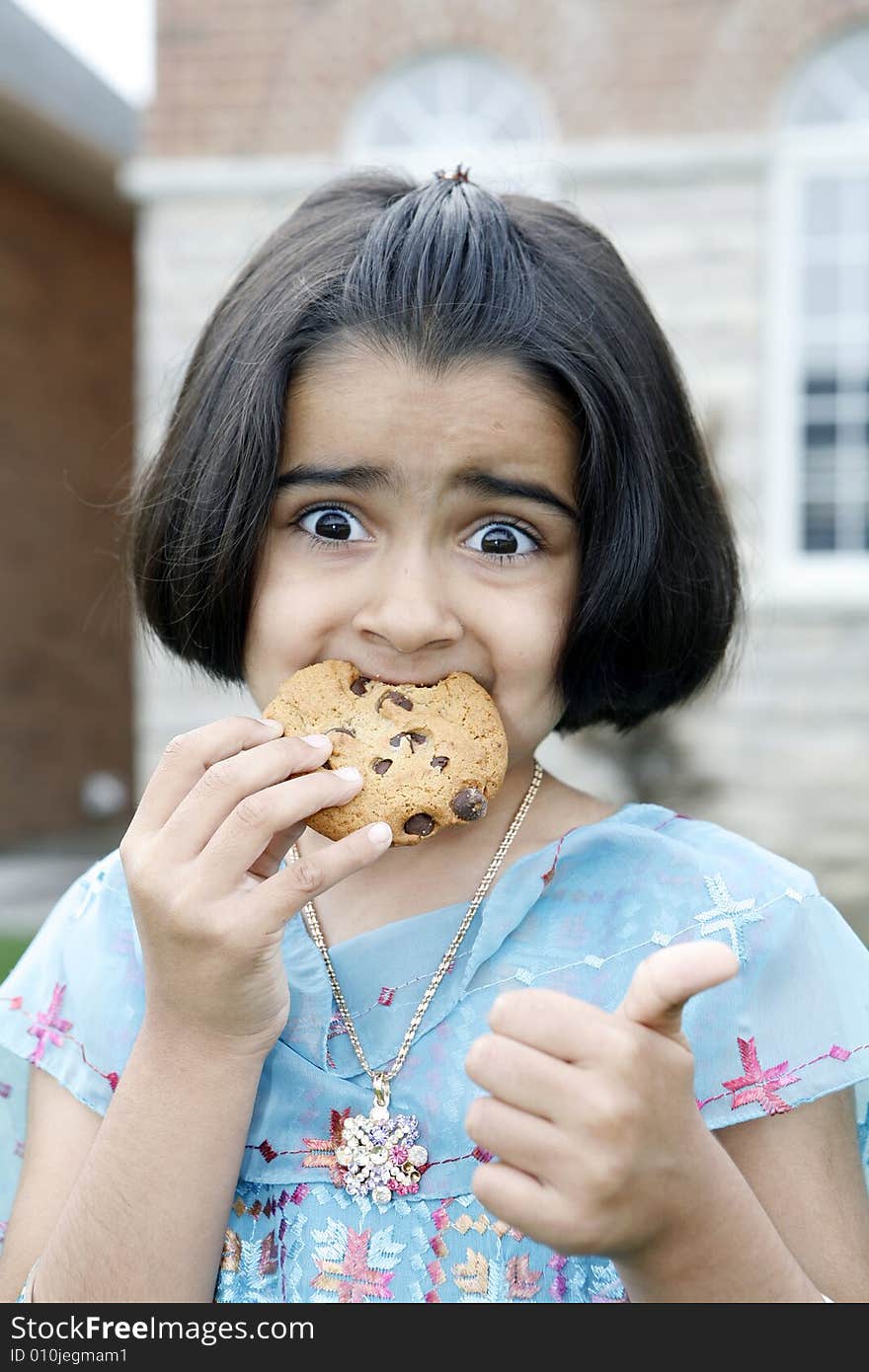 Little girl enjoying cookie