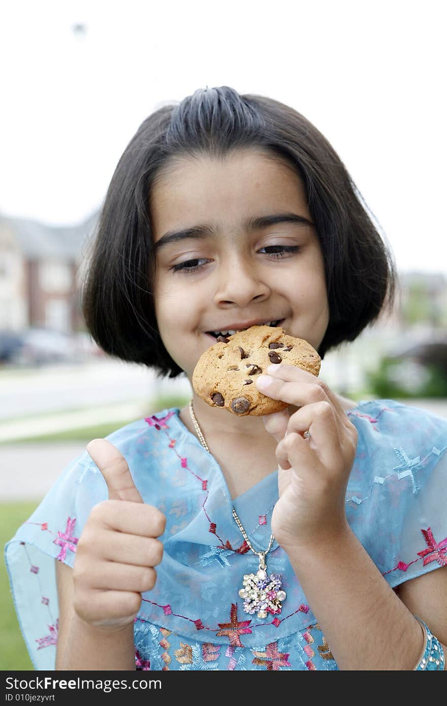 Little Girl Enjoying Cookie