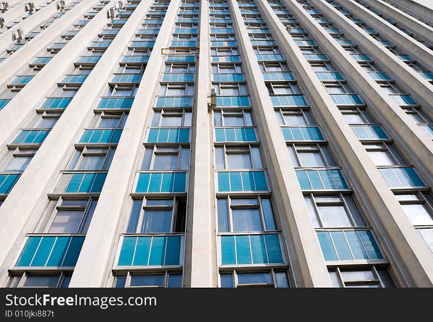 Tall office building exterior, perspective pattern with windows, wide angle shot