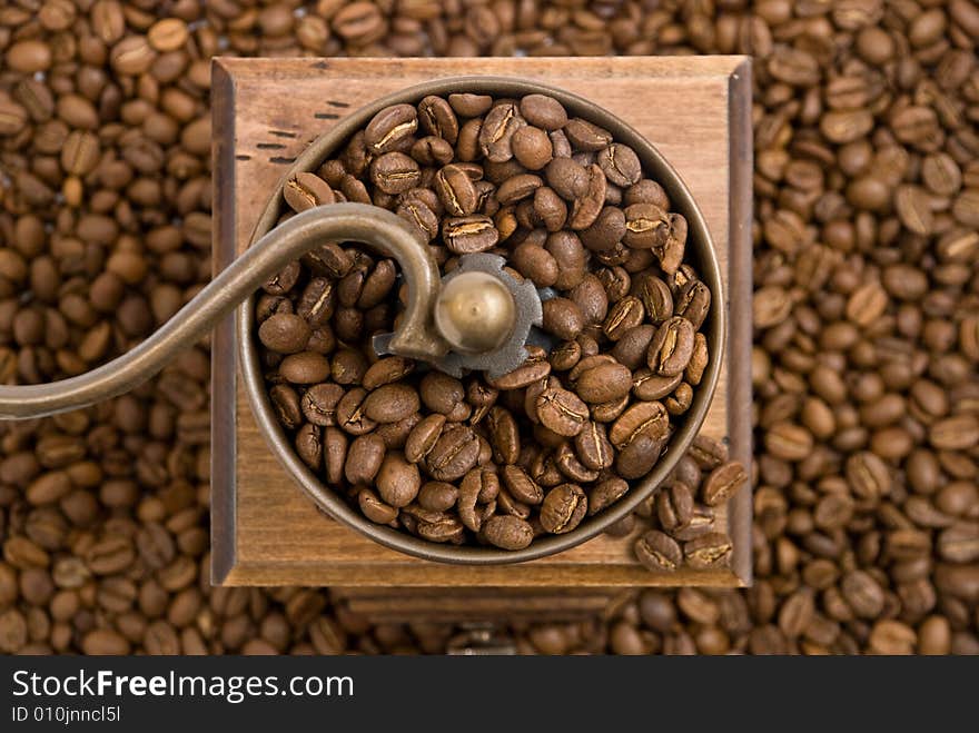 Old fashioned coffee grinder on the white background.