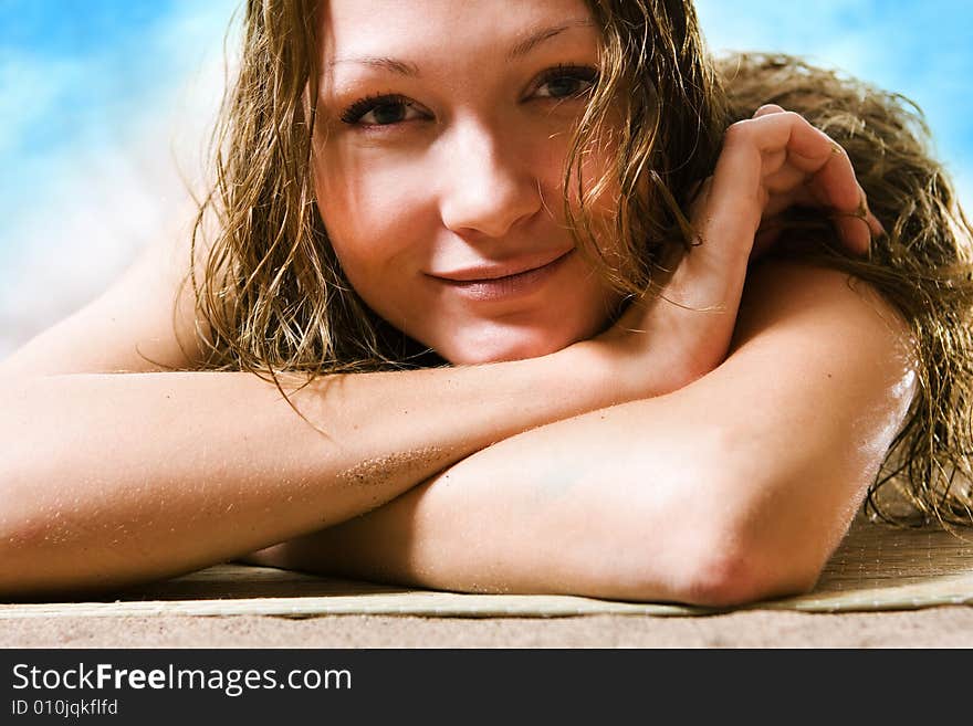 Beautiful girl in hat relaxing on the beach