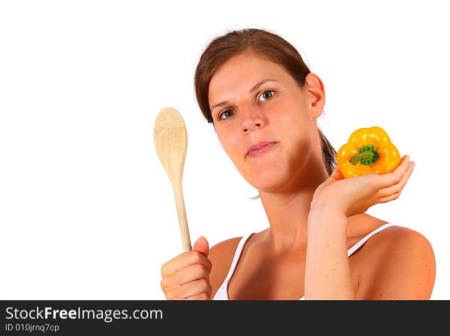 A young happy woman with vegetables and a spoon. Can be used as a cooking / diet shot. A young happy woman with vegetables and a spoon. Can be used as a cooking / diet shot.