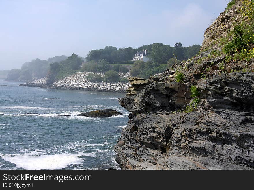 Waves crashing on a rocky shore and cliff. Waves crashing on a rocky shore and cliff