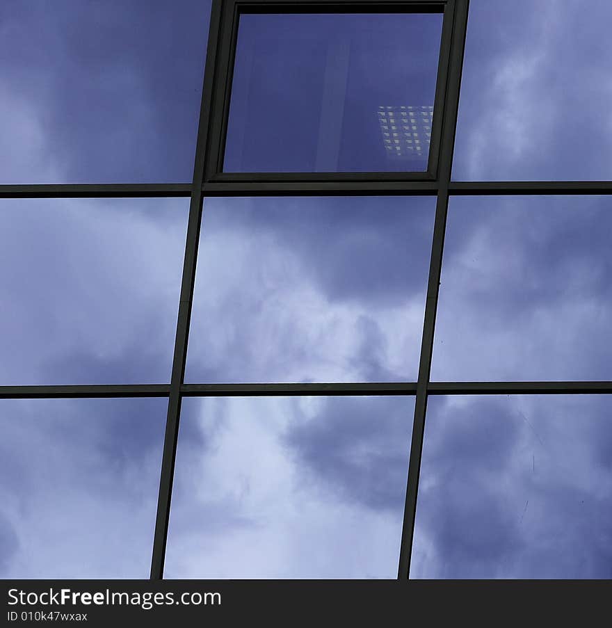 Cloud`s reflection in the office window. Cloud`s reflection in the office window